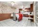 Eat-in kitchen with white tile floors, dark wood cabinets and adjacent dining area at 2209 Willoby Ct, Morrow, GA 30260