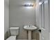 This bathroom offers a pedestal sink, toilet and lighting at 2477 Lakebrooke Dr, Marietta, GA 30066