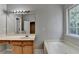 This bathroom features a vanity, sink, large mirror and tub at 2477 Lakebrooke Dr, Marietta, GA 30066