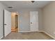 This carpeted bedroom offers two open doorways and neutral paint at 2477 Lakebrooke Dr, Marietta, GA 30066