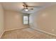 Bright bedroom featuring a window, ceiling fan, and neutral-colored carpet at 2477 Lakebrooke Dr, Marietta, GA 30066