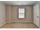 Neutral bedroom with beige carpet, white door, and window with blinds at 2477 Lakebrooke Dr, Marietta, GA 30066