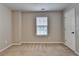 Neutral bedroom with beige carpet, white door, and window with blinds at 2477 Lakebrooke Dr, Marietta, GA 30066