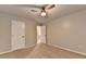 Bedroom with ceiling fan, plush carpet, and two doorways for convenient access at 2477 Lakebrooke Dr, Marietta, GA 30066