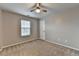 This bedroom includes a ceiling fan, carpet and a window at 2477 Lakebrooke Dr, Marietta, GA 30066