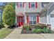 Inviting front entrance features a red door and manicured landscaping at 2477 Lakebrooke Dr, Marietta, GA 30066