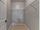 This laundry room includes tile flooring and wire shelving at 2477 Lakebrooke Dr, Marietta, GA 30066