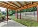Covered back patio with a view of the lush, green backyard and a classic wooden fence at 2477 Lakebrooke Dr, Marietta, GA 30066