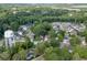 Aerial view of home near Buford, Georgia water tower, surrounded by green trees at 440 S Alexander St, Buford, GA 30518