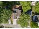 Aerial view of a single Gathering home with a driveway and mature trees surrounding the property at 440 S Alexander St, Buford, GA 30518