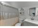 Well-lit bathroom featuring a shower-tub combination, floating shelves, and stylish vanity at 440 S Alexander St, Buford, GA 30518