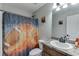 Clean bathroom with a shower-tub, custom sports-themed curtain, and vanity, creating a functional space at 440 S Alexander St, Buford, GA 30518