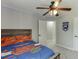Warm bedroom with wooden accents, ceiling fan, and convenient access to additional rooms at 440 S Alexander St, Buford, GA 30518