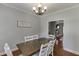 This dining room features a decorative chandelier and view to an inviting living room at 440 S Alexander St, Buford, GA 30518