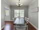 Traditional dining room with hardwood floors, a chandelier, and ample natural light at 440 S Alexander St, Buford, GA 30518