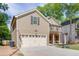 This home has an attached two-car garage and a welcoming front porch, providing convenient access and inviting curb appeal at 440 S Alexander St, Buford, GA 30518