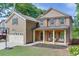 Charming two-story home with brick accents, a welcoming front porch, and a well-manicured lawn enhancing curb appeal at 440 S Alexander St, Buford, GA 30518