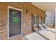 Covered front porch with brick facade and seating area at 440 S Alexander St, Buford, GA 30518