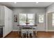 This kitchen features white cabinets, stainless appliances, and a dining area with stools at 440 S Alexander St, Buford, GA 30518