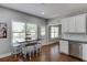 This kitchen features white cabinets, stainless appliances, and a dining area with stools at 440 S Alexander St, Buford, GA 30518