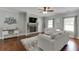 Spacious living room with a stone fireplace, hardwood floors, and large windows at 440 S Alexander St, Buford, GA 30518