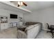Comfortable living room features a large sectional sofa, ceiling fan, and built-in bookshelves at 440 S Alexander St, Buford, GA 30518