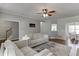 Open living room featuring neutral tones, hardwood floors, and a view into the dining room at 440 S Alexander St, Buford, GA 30518
