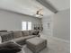 Open living room features a large sectional sofa, ceiling fan, and bright, neutral paint at 440 S Alexander St, Buford, GA 30518
