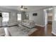 Bright living room with neutral tones, hardwood floors, and a view into the foyer at 440 S Alexander St, Buford, GA 30518