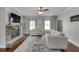 Bright and airy living room with a stone fireplace and hardwood floors at 440 S Alexander St, Buford, GA 30518