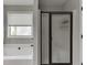 Bright main bathroom features a soaking tub and a separate, glass-enclosed shower at 440 S Alexander St, Buford, GA 30518