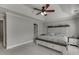 Bright main bedroom features tray ceilings, a ceiling fan, and neutral decor at 440 S Alexander St, Buford, GA 30518