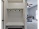 This mudroom features a built-in bench and coat hooks, with view to living room at 440 S Alexander St, Buford, GA 30518