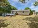 View of the home's backyard, featuring a wooden deck, a well-manicured lawn, and mature trees at 1886 Akron Se Dr, Atlanta, GA 30315