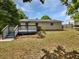 Backyard view featuring the home's exterior, lush lawn, and a blue-railed wooden deck at 1886 Akron Se Dr, Atlanta, GA 30315
