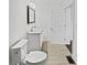 Updated bathroom featuring a toilet, vanity, mirror, and new tile flooring at 1886 Akron Se Dr, Atlanta, GA 30315