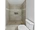 Modern walk-in shower featuring neutral tile, a built-in niche, and a rainfall showerhead at 1886 Akron Se Dr, Atlanta, GA 30315