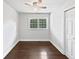 Bright bedroom with hardwood floors, ceiling fan, and a window offering natural light at 1886 Akron Se Dr, Atlanta, GA 30315