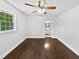Bedroom with hardwood floors, fan, and a glimpse into the adjacent bathroom at 1886 Akron Se Dr, Atlanta, GA 30315