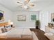 A staged bedroom with a ceiling fan, hardwood floors, natural light, and modern decor at 1886 Akron Se Dr, Atlanta, GA 30315