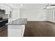 Open kitchen with white cabinets, granite island, stainless steel appliances, and hardwood floors at 1886 Akron Se Dr, Atlanta, GA 30315