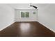 Bright, unstaged living room with hardwood floors and a large window that brings in natural light at 1886 Akron Se Dr, Atlanta, GA 30315
