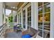 Charming balcony with comfortable wicker seating, perfect for enjoying the outdoor views through glass doors at 221 Thompson St, Alpharetta, GA 30009