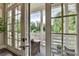 Scenic balcony view through French doors, featuring outdoor seating and lush greenery for a peaceful retreat at 221 Thompson St, Alpharetta, GA 30009
