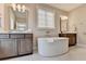 Well-appointed bathroom featuring a soaking tub, double vanities, and a window, offering a luxurious and functional space at 221 Thompson St, Alpharetta, GA 30009