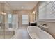 Bright bathroom with a freestanding tub, separate shower, and large window offering natural light and a spa-like feel at 221 Thompson St, Alpharetta, GA 30009