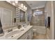 Well-lit bathroom features double sinks, a bathtub with shower, and modern fixtures, offering convenience and style at 221 Thompson St, Alpharetta, GA 30009