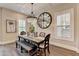 Elegant dining room features a chandelier, large mirror, and wood table with bench seating for stylish gatherings at 221 Thompson St, Alpharetta, GA 30009