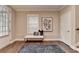 Stylish foyer featuring hardwood floors, a cozy bench, and a tasteful artwork, creating a welcoming ambiance at 221 Thompson St, Alpharetta, GA 30009