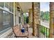 Inviting front porch features stone pillars, comfortable seating, and a peaceful view of the surrounding neighborhood at 221 Thompson St, Alpharetta, GA 30009
